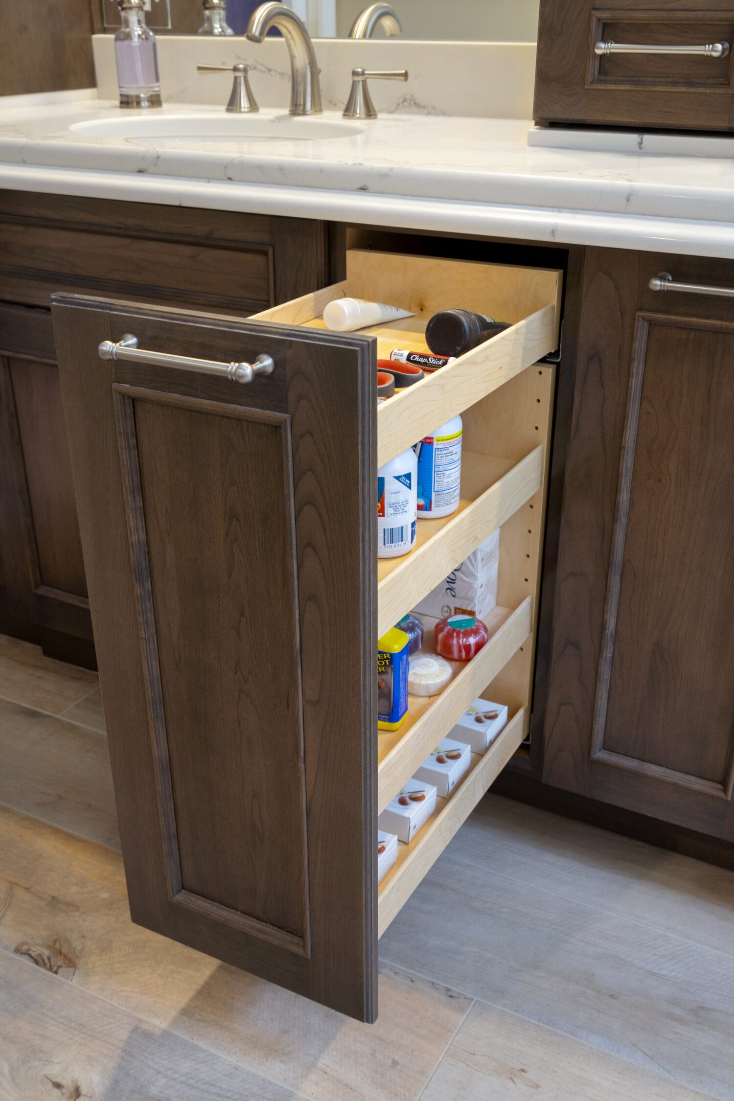 Vanity Pull-Out Storage Bathroom Cabinet Accessory has multiple shelves and full-access to the interior contents of the cabinet.